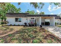 Charming single-story home with a well-maintained front yard and covered carport at 1520 Lakeside Way # 147, Sarasota, FL 34232