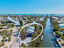 Beautiful waterfront home with lush landscaping and canal access, offering stunning views at 234 85Th St, Holmes Beach, FL 34217