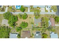 Wide aerial view of the property and surrounding neighborhood, showing ample lot size outlined in white at 275 Burke Rd, Venice, FL 34293