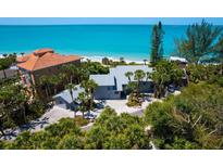 Beautiful beach home with lush tropical landscaping and stunning ocean views at 3201 Casey Key Rd, Nokomis, FL 34275