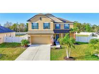 Inviting two-story home featuring well-manicured lawn, attached garage, and charming front-yard landscaping at 4010 Lindever Ln, Palmetto, FL 34221