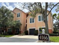Beautiful condo building with garages and lovely landscaping at 4166 Central Sarasota Pkwy # 535, Sarasota, FL 34238