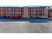 Exterior view of building with parking in front on a sunny day at 4186 Heron Way # B-219, Bradenton, FL 34205