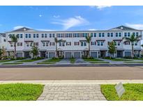 Beautiful new townhome exteriors featuring tropical landscaping, paver driveways, and covered entries at 1617 Sea Haven Dr # 501, Punta Gorda, FL 33950