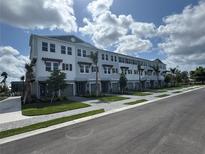 Attractive three-story townhouse units with manicured lawns and paved driveways on a sunny day at 1617 Sea Haven Dr # 502, Punta Gorda, FL 33950