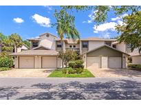 Attractive townhomes with garages and landscaping, creating curb appeal on a sunny day at 1712 Starling Dr # 101, Sarasota, FL 34231