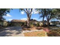Charming single-story home with a well-maintained lawn and mature trees, providing shade and curb appeal at 1810 Rudder Dr, Valrico, FL 33594