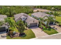 Lovely single Gathering home with beautiful tropical landscaping and brick paved driveway at 5009 Lake Overlook Ave, Bradenton, FL 34208