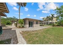 Charming backyard featuring a lovely patio, green grass, and beautiful landscaping that accents the home's exterior at 6718 68Th E Ave, Bradenton, FL 34203