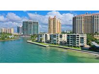 Scenic view of waterfront condos with easy water access and a clear view of the cityscape at 99 Sunset Dr # 102, Sarasota, FL 34236