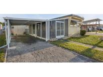 Charming exterior with a carport and screened-in porch for enjoying the outdoors at 1110 49Th Avenue W Dr, Bradenton, FL 34207