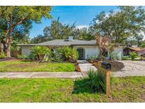 Charming single-story home with fresh landscaping, including palm trees and a well-maintained lawn at 11219 93Rd St, Largo, FL 33773