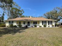 Charming single-story home with a front porch, manicured lawn, and lovely curb appeal at 12809 7Th Ne Ave, Bradenton, FL 34212
