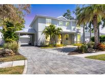Charming two-story home with paved driveway and tropical landscaping at 1815 Grove St, Sarasota, FL 34239