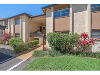Charming condo exterior featuring lush landscaping, a well-maintained facade, and inviting entryway at 2640 Clubhouse Dr # 204, Sarasota, FL 34232