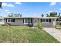 Charming single-story home with a well-maintained lawn and traditional architectural design details at 3041 Teal Ave, Sarasota, FL 34232