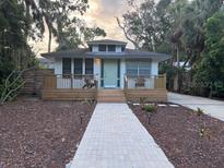 Charming single-story home with a welcoming front porch and a lovely brick walkway at 3312 Bay Shore Rd, Sarasota, FL 34234