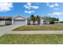 Charming single-story home boasts a well-maintained lawn and a two-car garage, enhancing its curb appeal at 4033 Dover E Dr, Bradenton, FL 34203