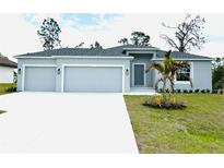 Charming single-Gathering home with a three-car garage and a well-maintained lawn at 5082 Rilke Ln, Port Charlotte, FL 33981