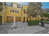 Attractive townhome with a two-car garage and well-manicured landscaping at 8827 White Sage Loop, Lakewood Ranch, FL 34202