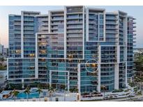 Modern, high-rise condominium building with sleek architectural design, multiple balconies, and views of the city and waterfront at 1155 N Gulfstream Ave # 706, Sarasota, FL 34236