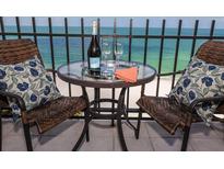 Relax on the balcony with seating, ocean views, and a table with champagne to enjoy the ocean breeze at 1212 Benjamin Franklin Dr # 901, Sarasota, FL 34236