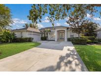Charming single-story home with manicured lawn and inviting front entrance with mature landscaping at 1217 92Nd Nw St, Bradenton, FL 34209