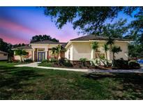 Charming home featuring manicured landscaping, a walkway, and a stylish blue front door at 14104 E 22Nd Ter, Bradenton, FL 34212