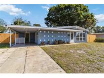 Charming single-story home featuring a covered carport, well-maintained lawn, and inviting curb appeal at 2400 Stanford Ave, Bradenton, FL 34207