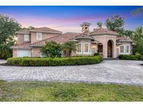 Attractive property with a paved driveway, manicured hedges, and a well-maintained lawn at 3905 Trentwood Pl, Sarasota, FL 34243