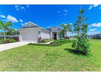 Charming single-story home boasts a lush lawn and tropical landscaping at 4324 Sea Marsh Pl, Parrish, FL 34219