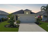 Charming single-Gathering home featuring a two-car garage, well-maintained lawn, and beautiful landscaping at 4839 Deep Creek Ter, Parrish, FL 34219