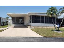 Charming single-story home featuring a screened-in porch, mature landscaping, and a cozy curb appeal at 5536 Denmark Dr, Bradenton, FL 34207