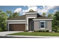 Beautiful single-Gathering home featuring a two-car garage, lush landscaping, and architectural details at 6908 Prairie Oak Way, Nokomis, FL 34275