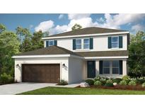 Charming two-story home with attached garage, lush landscaping, and classic design elements at 7053 Foxboro Way, Nokomis, FL 34275
