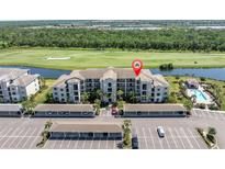 Beautiful condo building overlooks golf course, lake, community pool and covered parking at 17810 Gawthrop Dr # 406, Bradenton, FL 34211