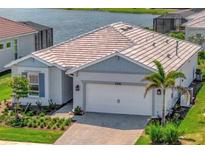 Beautiful single-story home with a two-car garage and well-maintained landscaping near the water at 27061 Paradise Shores Dr, Englewood, FL 34223