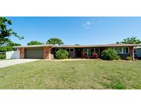 Charming single-story home with a manicured lawn, brick accents, and a two-car garage at 4616 22Nd W Ave, Bradenton, FL 34209