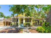 Charming yellow home with inviting front porch and well-manicured landscaping at 4721 Garcia Ave, Sarasota, FL 34233