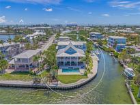Stunning waterfront home with a private pool and boat dock, offering direct access to the open water at 526 56Th St, Holmes Beach, FL 34217