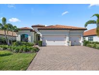 Lovely home with a three-car garage, clay tile roof and lush landscaping at 7113 Whittlebury Trl, Bradenton, FL 34202