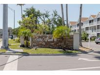 Community sign for Central Park II with lush landscaping and palm trees on a sunny day at 850 S Tamiami Trl # 836, Sarasota, FL 34236