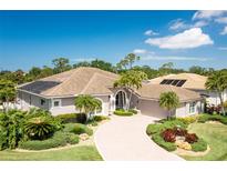 Stunning single-story home featuring a paver driveway, meticulously landscaped yard, and well-maintained tile roof at 8712 Grey Oaks Ave, Sarasota, FL 34238