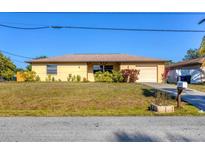 Charming single-story home featuring a neatly landscaped front yard and an attached one-car garage at 2707 Vinson Ave, Sarasota, FL 34232
