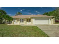 Charming single-story home with a well-manicured lawn, tidy landscaping, and a two-car garage at 3522 Ferndell, Sarasota, FL 34235