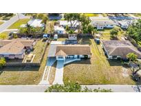 Aerial view of a single-Gathering home with a long driveway and mature trees in a residential neighborhood at 432 Crosby Ct, Sarasota, FL 34237