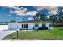 Charming single-story home with a well-manicured lawn, updated roof, and lovely landscaping at 466 Sunnyside Dr, Venice, FL 34293