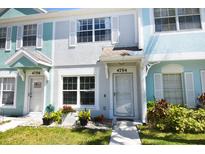 Charming multi-colored townhome featuring a well-manicured lawn and bright curb appeal at 4754 Sabal Key Dr, Bradenton, FL 34203