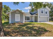 Charming two-story home with a well-maintained lawn and neutral gray paint scheme at 5642 29Th Street E Cir, Bradenton, FL 34203