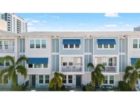 Beautiful townhome exteriors featuring blue awnings, private balconies, and lush tropical landscaping at 845 Burlington N Ave, St Petersburg, FL 33701